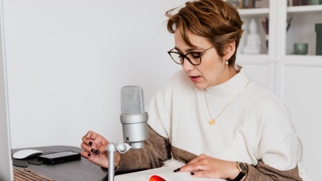 A women recordings her Audiobook narration with a mic.