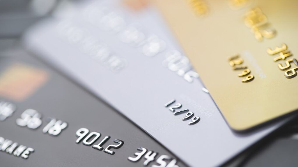 a closeup image of 3 credit cards decked one on another.